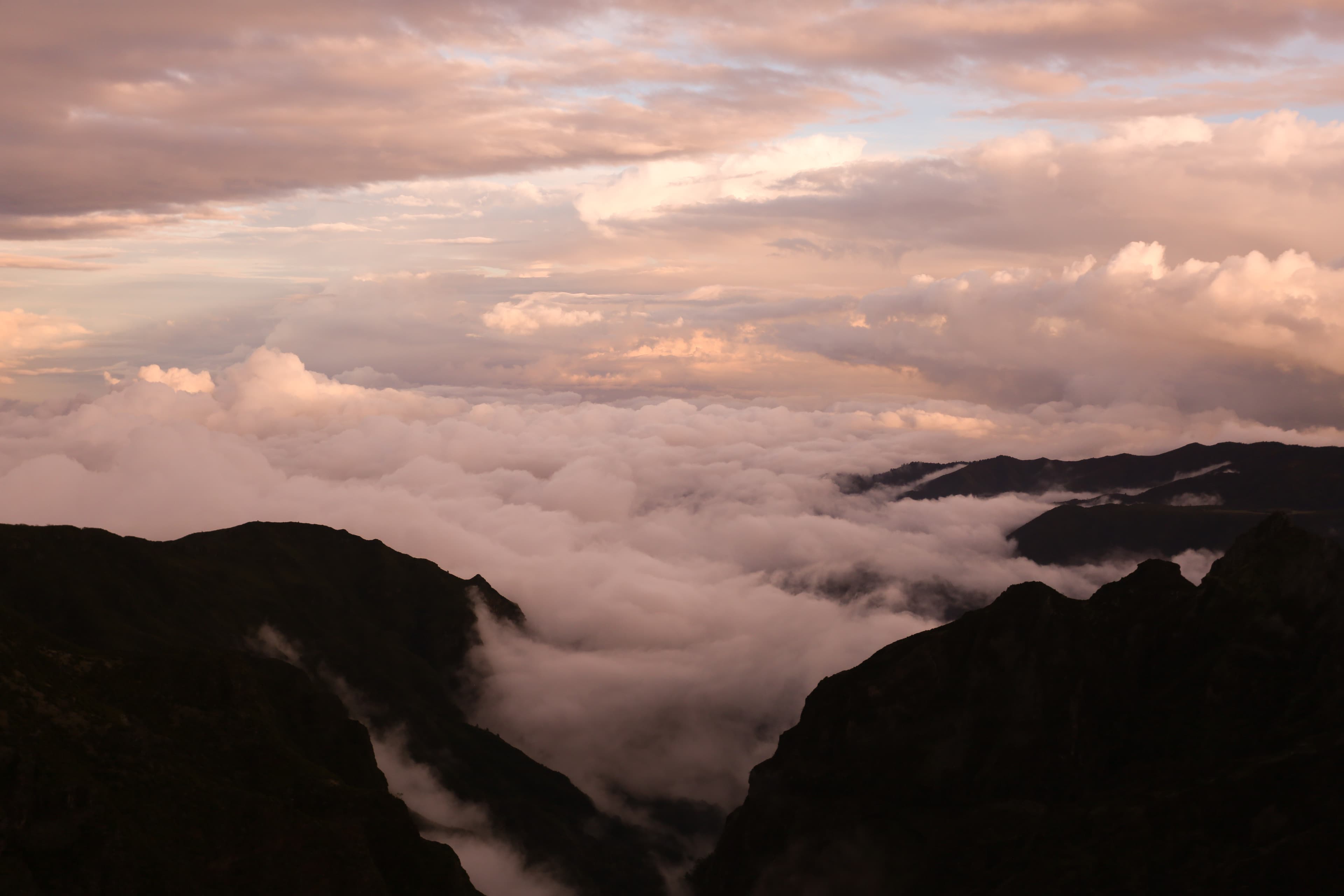 Sunset view from the summit of Pico Ruivo, Madeira, looking out over a sea of clouds filling the mountain valleys